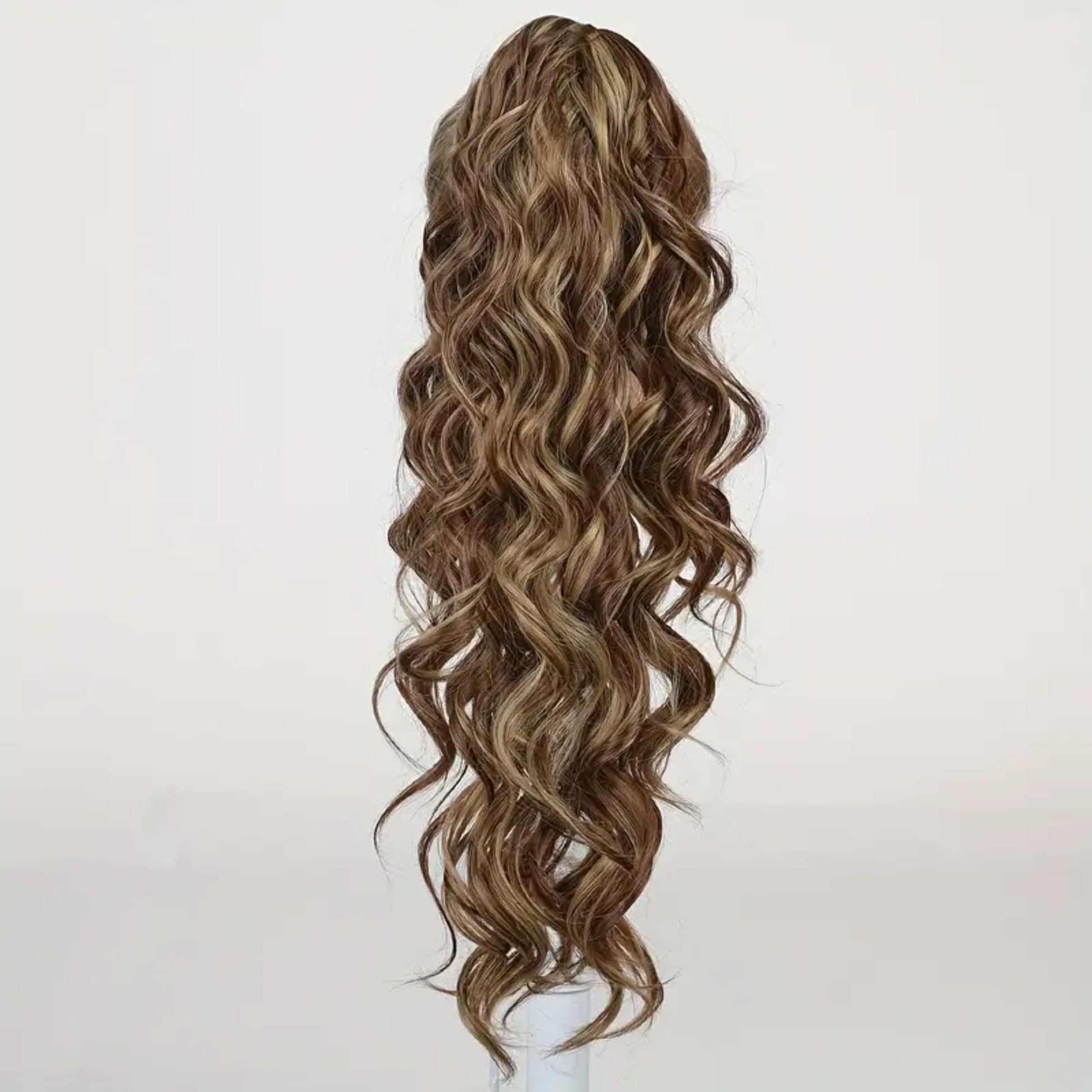 22-inch long wavy synthetic claw clip ponytail hair extension featuring highlighted brown to light brown tones for an instant voluminous and natural-looking hairstyle.