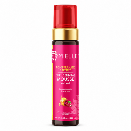 Pink bottle of Mielle Pomegranate & Honey Curl Defining Mousse with a red and gold cap on a white background